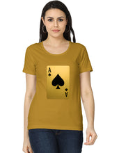 Woman wearing a mustard yellow t-shirt with a playing card design on a white background