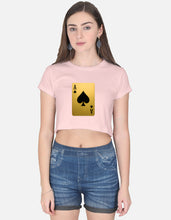 Woman wearing a pink t-shirt with a playing card design and blue shorts on a white background