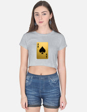 Woman wearing a gray t-shirt with a playing card design and denim shorts on a white background