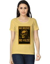 Woman wearing a yellow t-shirt with a skull and headphones design and text 'NO MUSIC NO PULSE'.