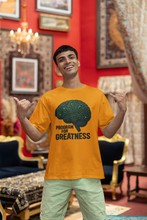 Man wearing a yellow t-shirt with a brain graphic and 'Program for Greatness' text in an ornate room.