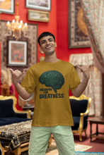 Man wearing a yellow t-shirt with a brain graphic and text, standing in an ornate room.
