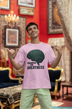 Man wearing a pink t-shirt with a brain graphic and text in an ornate room.