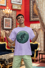Man wearing a t-shirt with a 'Find Your Peace' design in a decorated room.