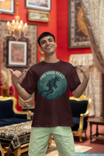 Man wearing a t-shirt with a 'Find Your Peace' design in a decorated room.