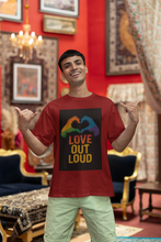 Man wearing a red t-shirt with 'Love Out Loud' design in a decorated room.