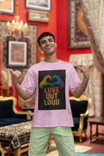 Person wearing a t-shirt with 'Love Out Loud' design in a decorated room.