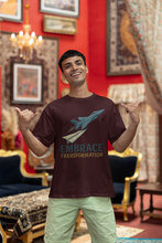 Man wearing a t-shirt with 'Embrace Transformation' text in an ornate room.