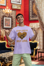 Man wearing a t-shirt with 'Stop Loss is Self Love' design in a decorated room.