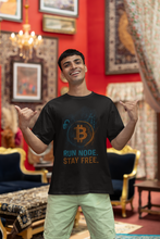 Man wearing a black t-shirt with Bitcoin design and text in an ornate room.