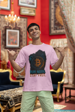 Man wearing a pink t-shirt with Bitcoin design in an ornate room