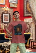 Man wearing a red t-shirt with Bitcoin design in an ornate room