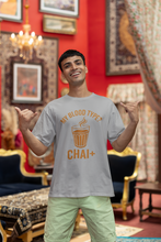 Man wearing a t-shirt with a humorous design in an ornate room.