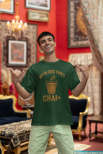 Man wearing a green t-shirt with 'My Blood Type? Chai' design in a decorated room.