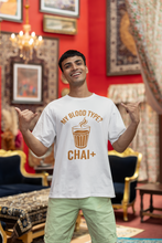 Man wearing a white t-shirt with a humorous coffee-themed design in an ornate room.