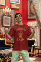 Man wearing a red t-shirt with a humorous design in an ornate room.
