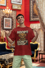 Man wearing a red 'Adopt Don't Shop' t-shirt in an ornate room.