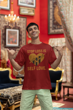 Man wearing a red t-shirt with a motivational message in an ornate room.
