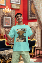 Man wearing a 'Adopt Don't Shop' t-shirt in a decorated room.