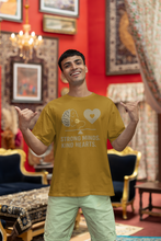 Man wearing a yellow t-shirt with a graphic design and text in a decorated room.