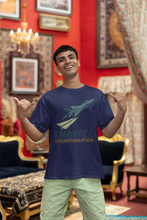 Man wearing a navy blue t-shirt with 'Embrace Transformation' text and airplane graphic in a decorated room.