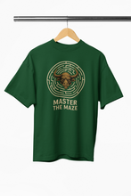 Green t-shirt with bull head maze design and 'Master the Maze' text on a hanger.