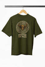 Green t-shirt with bull maze graphic and 'Master the Maze' text on a hanger against a white background