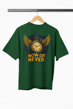 Green t-shirt with a clock design and 'NOW OR NEVER' text on a hanger against a white background