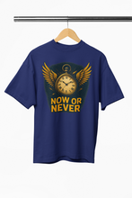 Navy blue t-shirt with a clock graphic and 'NOW OR NEVER' text on a hanger.