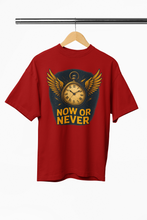 Red t-shirt with a clock graphic and 'NOW OR NEVER' text on a hanger against a white background