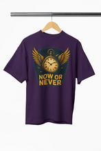 Purple t-shirt with a clock design and 'NOW OR NEVER' text on a hanger.
