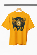 Yellow t-shirt with a clock design and 'Now or Never' text on a hanger against a white background