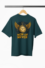 Green t-shirt with a clock graphic and 'NOW OR NEVER' text on a hanger against a white background