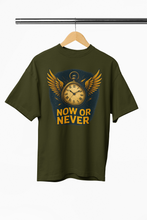 Green t-shirt with a clock graphic and 'NOW OR NEVER' text on a hanger against a white background