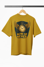 Yellow t-shirt with a clock design and 'NOW OR NEVER' text on a hanger against a white background