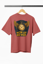 Red t-shirt with a clock design and 'Now or Never' text on a hanger against a white background