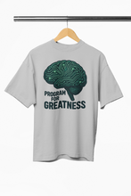 Gray t-shirt with a brain graphic and 'Program for Greatness' text on a hanger against a white background