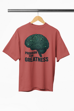 Red t-shirt with brain graphic and 'Program for Greatness' text on a hanger against a white background