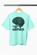 Mint green t-shirt with brain graphic and 'Program for Greatness' text on a hanger.