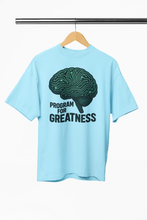 Light blue t-shirt with a brain graphic and 'Program for Greatness' text on a hanger.