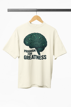 White t-shirt with brain graphic and 'Program for Greatness' text on a hanger.