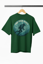 Green t-shirt with a graphic and 'Find Your Peace' text on a hanger