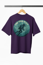 Purple t-shirt with a graphic of a diver and 'Find Your Peace' text on a hanger.