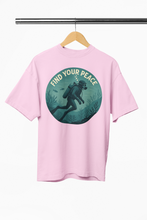 Pink t-shirt with 'Find Your Peace' graphic on a hanger against a white background