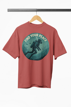 Red t-shirt with a graphic of a diver and 'Find Your Peace' text on a hanger against a white background