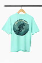 Mint green t-shirt with 'Find Your Peace' graphic on a hanger against a white background