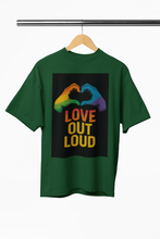 Green t-shirt with rainbow hands and 'Love Out Loud' text on a hanger against a white background