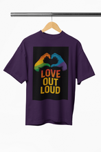 Purple t-shirt with rainbow hands and 'Love Out Loud' text on a hanger against a white background