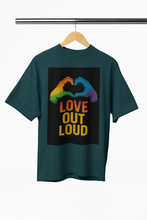 Green t-shirt with 'Love Out Loud' graphic on a hanger against a white background