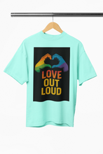Light blue t-shirt with rainbow hands and 'Love Out Loud' text on a hanger against a white background